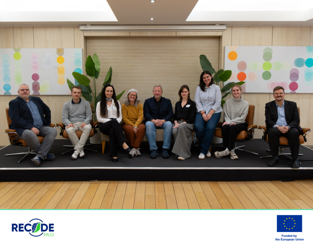 Nine workshop participants seated together on a low stage at Norway House in Brussels. The image has a RECODE MLG and Funded by the European Union footer.